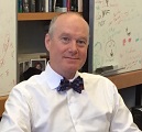 Dr. Daniel Griffin is wearing a white shite and dark colored bow tie. He is facing the camera with a slight smile. 