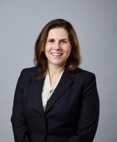 Sarah M. Benish, MD, FAAN, is a professor of neurology and vice chair of clinical affairs at the University of Minnesota.  Dr. Benish has shoulder length brown hair and is wearing a cream blouse and black suite jacket. She is smiling facing the camera.