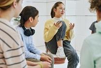 Portrait of teenage girl sharing feelings in support group circle for children