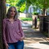 Dr. Tracey Gendron leaning against a tree.